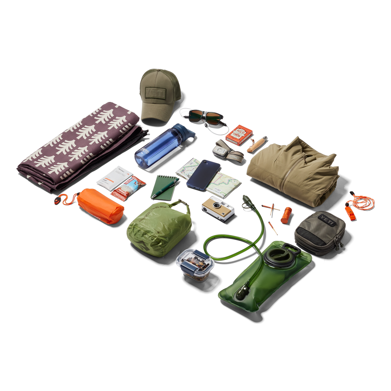 Collection of outdoor gear including a hat, sunglasses, camera, and various bags on a white background