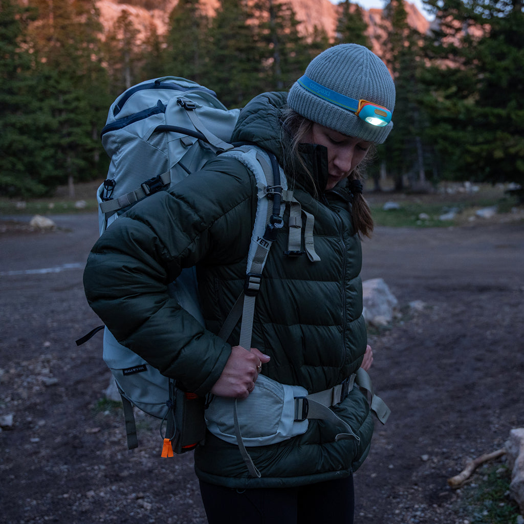 Person with a large backpack in a forest setting