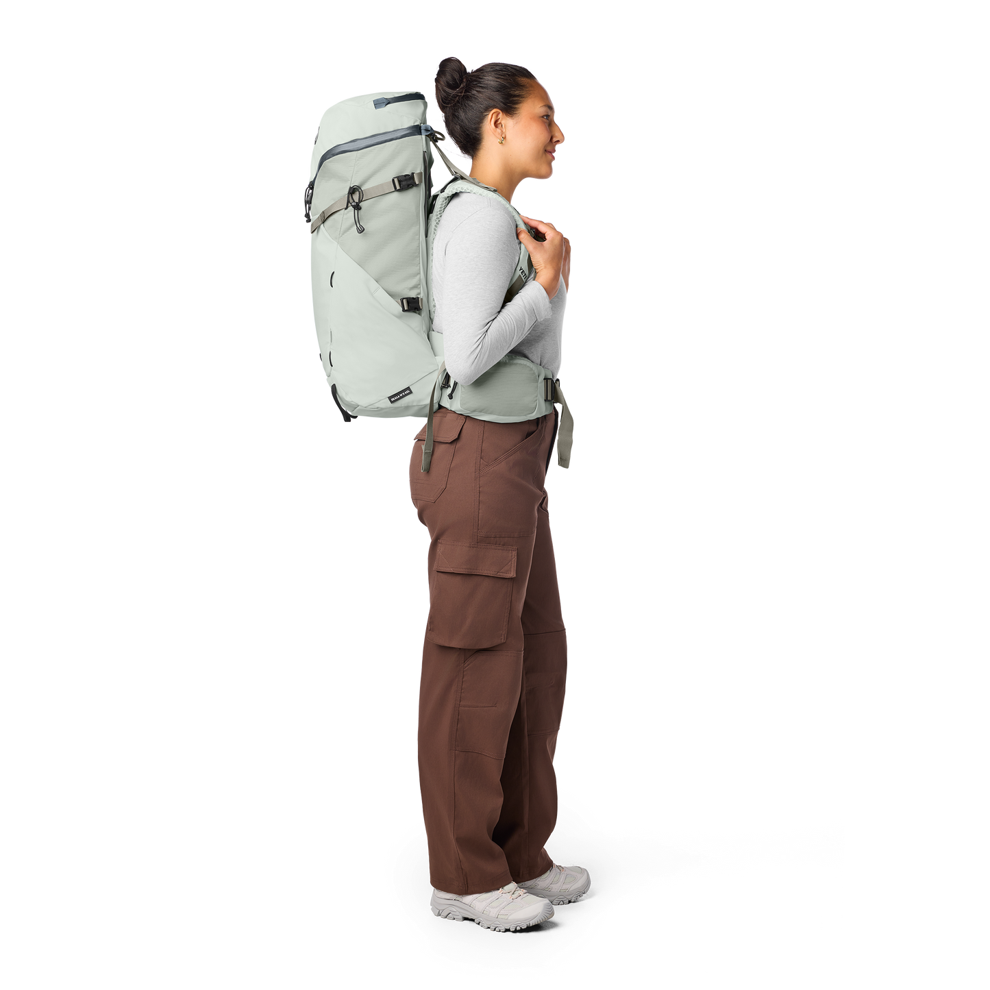 Person wearing a large white backpack on a white background